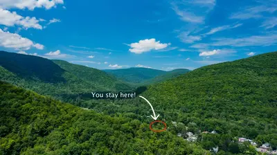 an aerial view of a forested area with a red circle at 1920s Phoenicia Bungalow with Vintage Furnishings, Sauna, Fireplace, & Fenced Backyard in Phoenicia