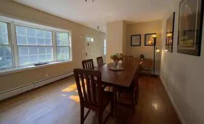 a dining room with a wooden table and chairs at Unique Ski Rental in Berkshires Charlemont Near Hawley State Forest, Plainfield, Western Massachusetts in Plainfield