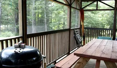a large screened in porch with a table and a grill at Unique Ski Rental in Berkshires Charlemont Near Hawley State Forest, Plainfield, Western Massachusetts in Plainfield