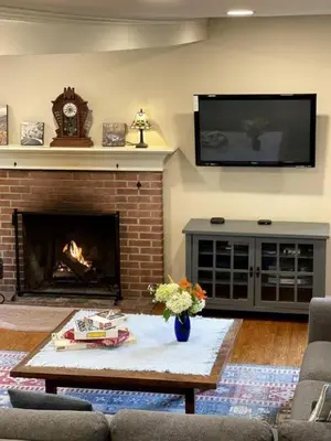 a living room with a fireplace and a tv at Unique Ski Rental in Berkshires Charlemont Near Hawley State Forest, Plainfield, Western Massachusetts in Plainfield