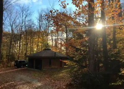 a small building in the middle of a forest at Imaginative Octogonal Glass Treehouse on Seven Private Acres near Great Barrington, MA in Great Barrington