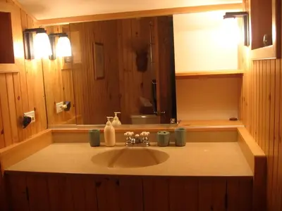 a bathroom with a sink and a mirror at Charming Cabin with Serene Lake Views for a Family Getaway near Pittsfield, Massachusetts in Pittsfield