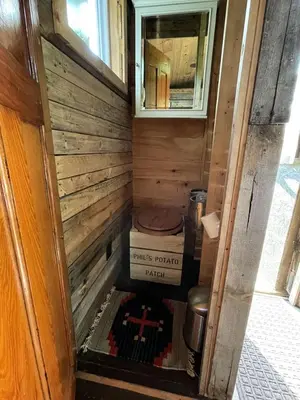 a small house with a toilet and a window at Gorgeous Tiny House Rental for a Glamping Getaway near Saratoga Springs in Upstate New York in Argyle