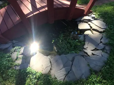 an overhead view of the sun shining through a wooden bridge at Authentic Mongolian Yurt for a Serene Healing Retreat in Saratoga Springs, New York in Saratoga Springs