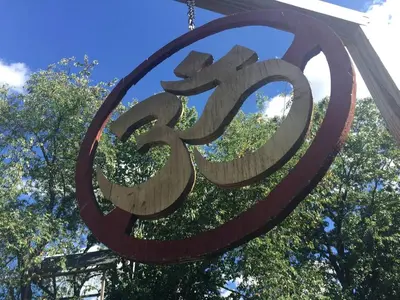 a large metal sign with chinese writing on it at Authentic Mongolian Yurt for a Serene Healing Retreat in Saratoga Springs, New York in Saratoga Springs