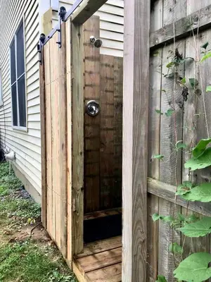 a wooden entrance to a house with a wooden door at Authentic Mongolian Yurt for a Serene Healing Retreat in Saratoga Springs, New York in Saratoga Springs