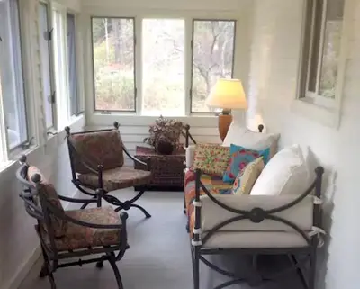 a living room with chairs and a lamp and windows at Secluded Cabin with Gorgeous Views near Stockbridge in the Berkshires of Massachusetts in Stockbridge
