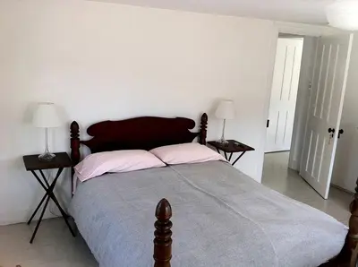 a bedroom with a large bed with two night stands at Minimalist Countryside Villa Rental near Albany in Upstate New York in West Fulton