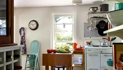 a kitchen with a table and a clock on the wall at Minimalist Countryside Villa Rental near Albany in Upstate New York in West Fulton