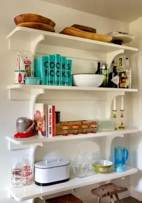 a shelf with dishes and other kitchen items on it at Minimalist Countryside Villa Rental near Albany in Upstate New York in West Fulton