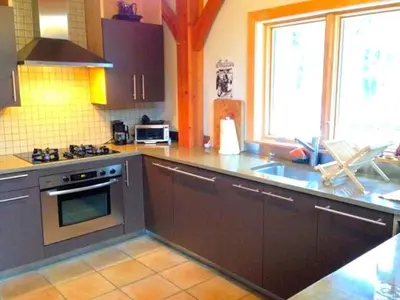 a kitchen with a sink and a stove top oven at Beautiful Two-Bedroom Cabin Rental Set in the Forests of the Berkshires, Massachusetts
