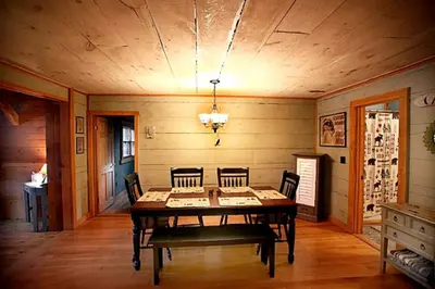 a dining room with a wooden table and chairs at Lakefront Cabin Getaway near Adirondack Mountains in Salisbury, New York