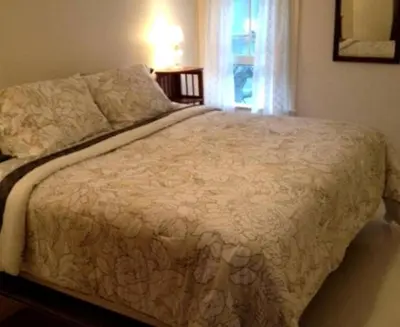a large bed in a bedroom with a window at Riverfront Cabin with Beautiful Views of Housatonic River in Great Barrington, Massachusetts in Housatonic