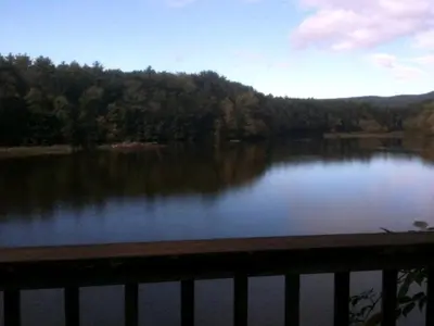 a view of a lake from a balcony at Riverfront Cabin with Beautiful Views of Housatonic River in Great Barrington, Massachusetts in Housatonic