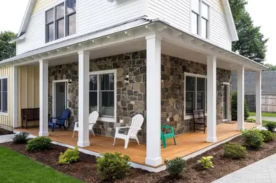 a porch of a house with chairs and a table at Beautiful Cottage Rental on Lakeside Property in Berkshires, Massachusetts in Lanesborough