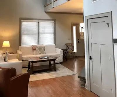 a living room with a couch and a table at Beautiful Cottage Rental on Lakeside Property in Berkshires, Massachusetts in Lanesborough