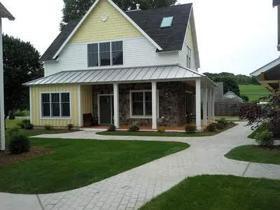 a white house with a porch and a driveway at Beautiful Cottage Rental on Lakeside Property in Berkshires, Massachusetts in Lanesborough