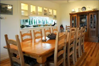 a dining room with a wooden table and chairs at Impressive Cabin with a Pool and Hot Tub Ideal for Weekend Getaways in the Catskills in Hunter