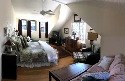 a living room with a bed and a couch at Impressive Cabin with a Pool and Hot Tub Ideal for Weekend Getaways in the Catskills in Hunter