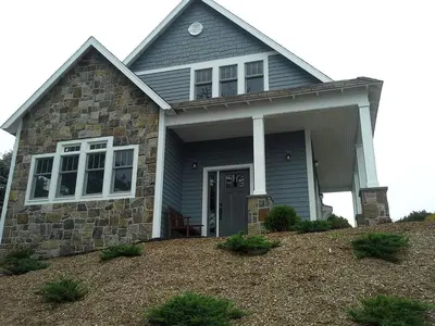 a house with a front door and a yard at Spacious Guest Cottage Rental on Lake in Berkshires, Massachusetts in Lanesborough