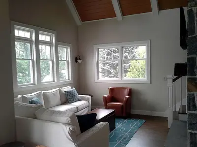 a living room with two white couches and a chair at Spacious Guest Cottage Rental on Lake in Berkshires, Massachusetts in Lanesborough