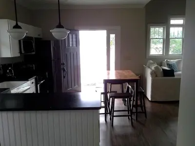 a kitchen and living room with a table and chairs at Spacious Guest Cottage Rental on Lake in Berkshires, Massachusetts in Lanesborough
