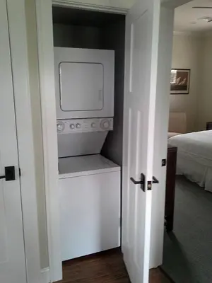 a kitchen with a stove in a room with a bed at Spacious Guest Cottage Rental on Lake in Berkshires, Massachusetts in Lanesborough
