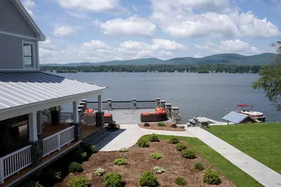 a house with a view of a lake at Impressive Family-Friendly Lake Cottage in Berkshires, Massachusetts in Lanesborough