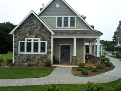 a house with a stone at Impressive Family-Friendly Lake Cottage in Berkshires, Massachusetts in Lanesborough