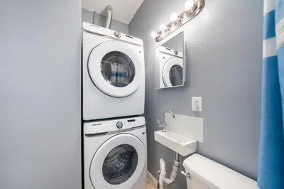 a bathroom with a washing machine and a sink at Newark 3BR Gem - Near NYC - & Attractions in Newark