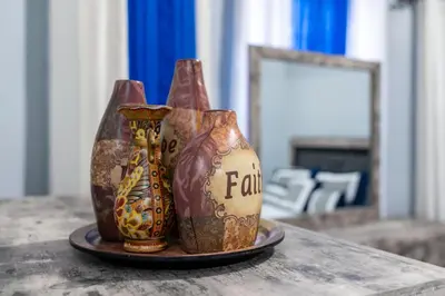 three vases sitting on a plate on a table at Newark 3BR Gem - Near NYC - & Attractions in Newark