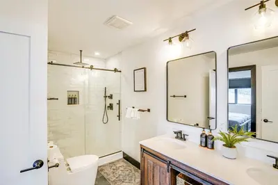 a bathroom with a sink and a toilet and a mirror at Lux Windham Getaway - Views & Indoor Heated Pool in Windham