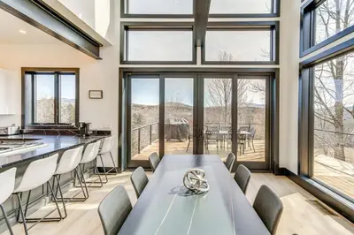 a dining room with a long table and chairs at Lux Windham Getaway - Views & Indoor Heated Pool in Windham