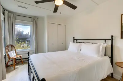 a bedroom with a large bed with a ceiling fan at Walk to White Lake Family Home with Deck and BBQ in White Lake