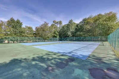 a tennis court with a net on top of it at Poconos Hot Tub Haven! 14 Mi to Camelback Resort in Pocono Country Place