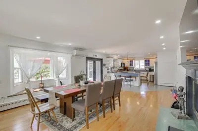 a kitchen and dining room with a table and chairs at Lake Carmel Access Waterfront Home with Deck! in Carmel