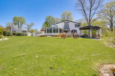 a large yard with a house with a gazebo at Lake Carmel Access Waterfront Home with Deck! in Carmel