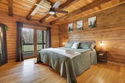 a bedroom with a bed and a ceiling fan at Secluded Escape - PAN's Wooden Casita in Lake Ariel