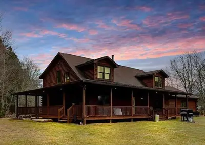 a large wooden house with a large deck at Secluded Escape - PAN's Wooden Casita in Lake Ariel