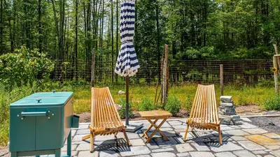 two chairs and a picnic table and an umbrella at PoolHot Tub Firepit Near Hikes Shops Dining Cragswood Lodge by AvantStay in New Paltz