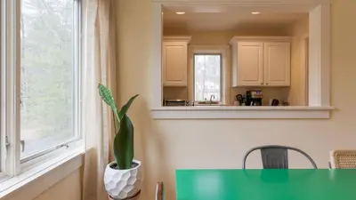 a kitchen with a green table and a window at PoolHot Tub Firepit Near Hikes Shops Dining Cragswood Lodge by AvantStay in New Paltz