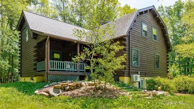 a log cabin in the woods with a yard at PoolHot Tub Firepit Near Hikes Shops Dining Cragswood Lodge by AvantStay in New Paltz