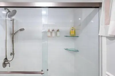 a bathroom with a shower with a glass door at Cozy Andes Cabin with Scenic Views in Andes