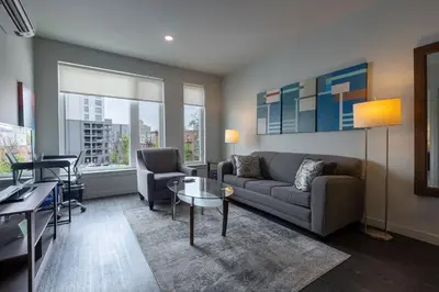 a living room with a couch and a table at Luxury Apt Downtown in White Plains