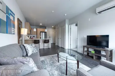 a living room with a couch and a glass table at Luxury Apt Downtown in White Plains
