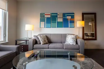 a living room with a couch and a glass table at Luxury Apt Downtown in White Plains