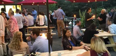 a group of people sitting at tables in a party at Jessie's Harvest House in Tannersville