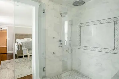 a white bathroom with a shower with a glass door at Luxury Stay In Expansive Historical Home in North Haven