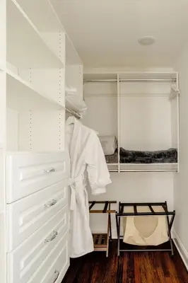 a white closet with a dresser and a robe at Luxury Stay In Expansive Historical Home in North Haven