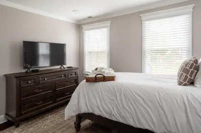 a bedroom with a flat screen tv and a bed at Luxury Stay In Expansive Historical Home in North Haven